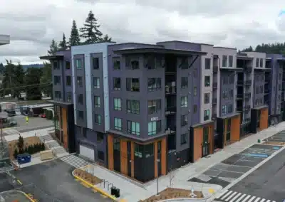 Aerial view of multifamily building with panel siding