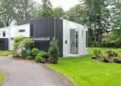 White and charcoal modern home with landscaping