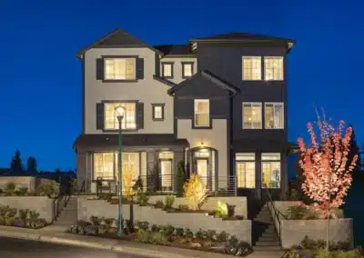 Three-story home with shingle siding at twilight