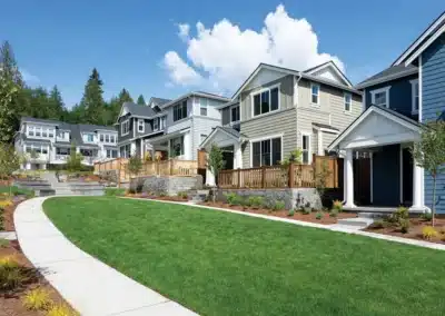 Hillside homes with siding and a curved walkway