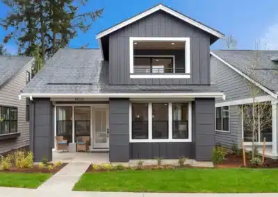 Cottage row with siding and a curved walkway at twilight