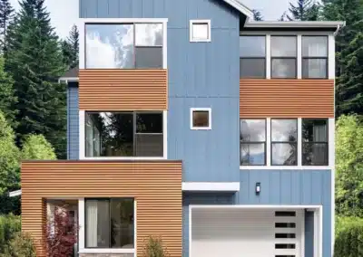 Blue panel siding home with cedar accent bands