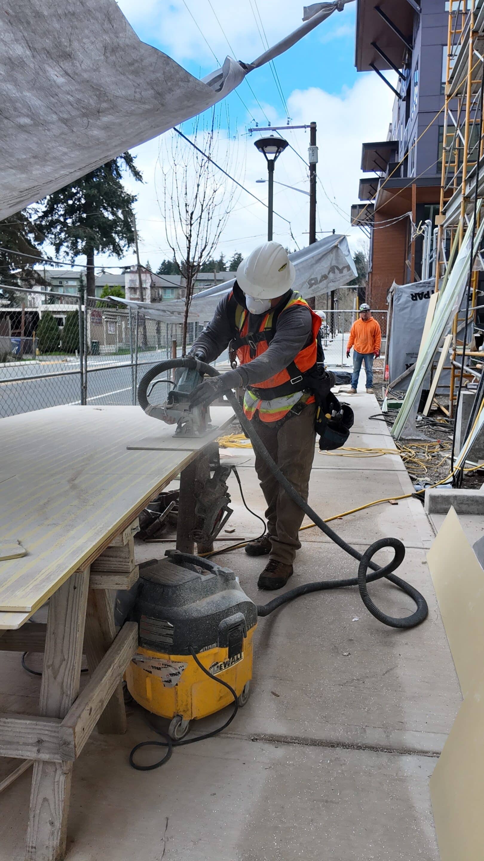 Side-Pro crew cutting fiber cement with a dust-extraction vacuum Side-Pro crew cutting fiber cement with a dust-extraction vacuum