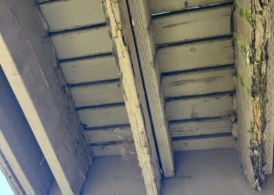 Underside of an exterior stair at Phoenix Court Apartments before renovation.