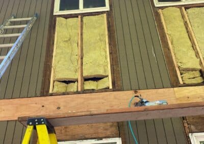An elevation stripped back to the sheathing at Phoenix Court Apartments.
