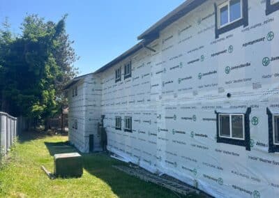 A full elevation covered in weather barrier at Phoenix Court Apartments.