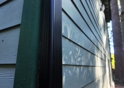 Lap siding meeting a dark trim board at Westboro Condos, Federal Way WA.